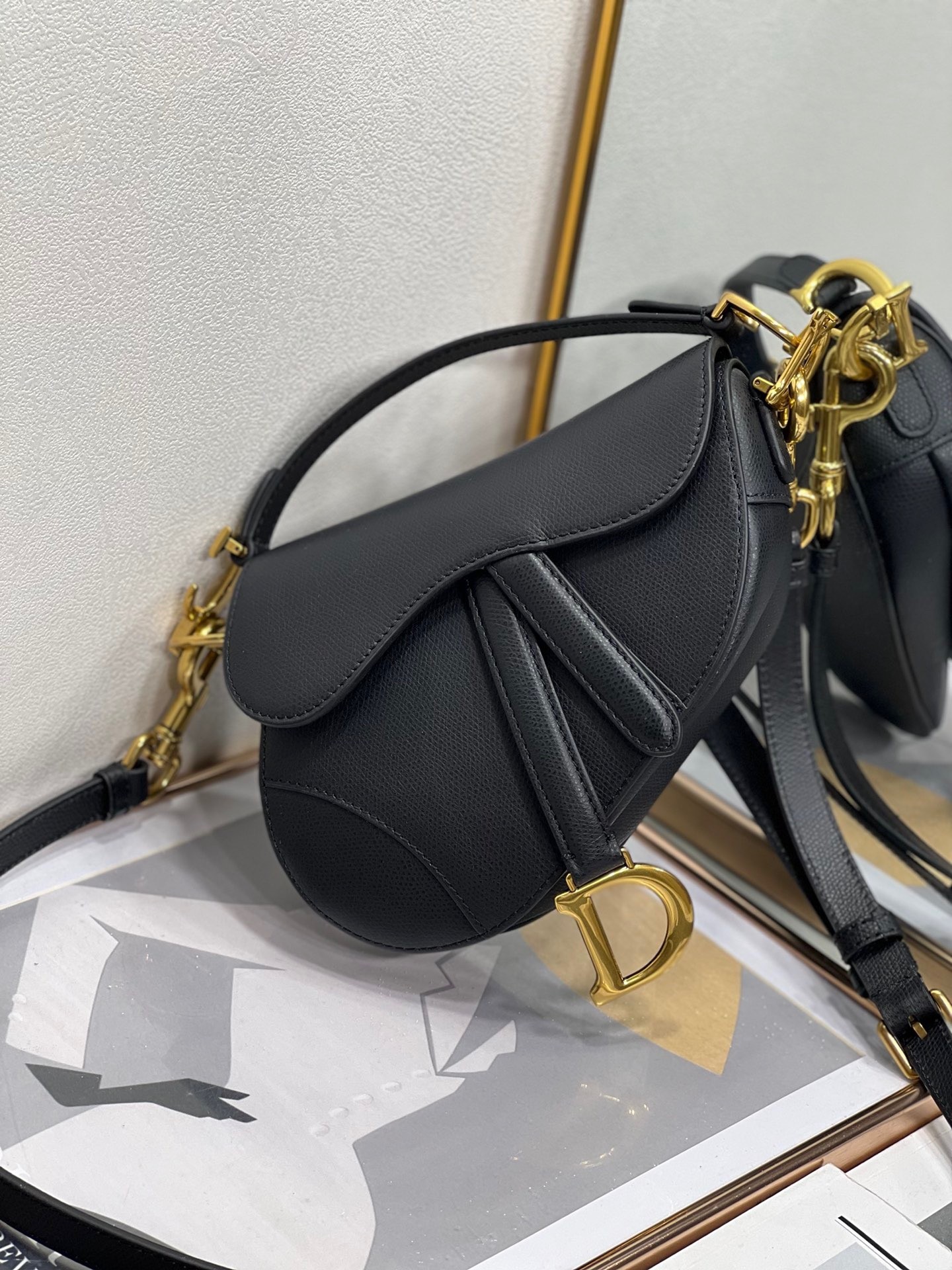 D*or saddle mini bag with strap in black grained calfskin