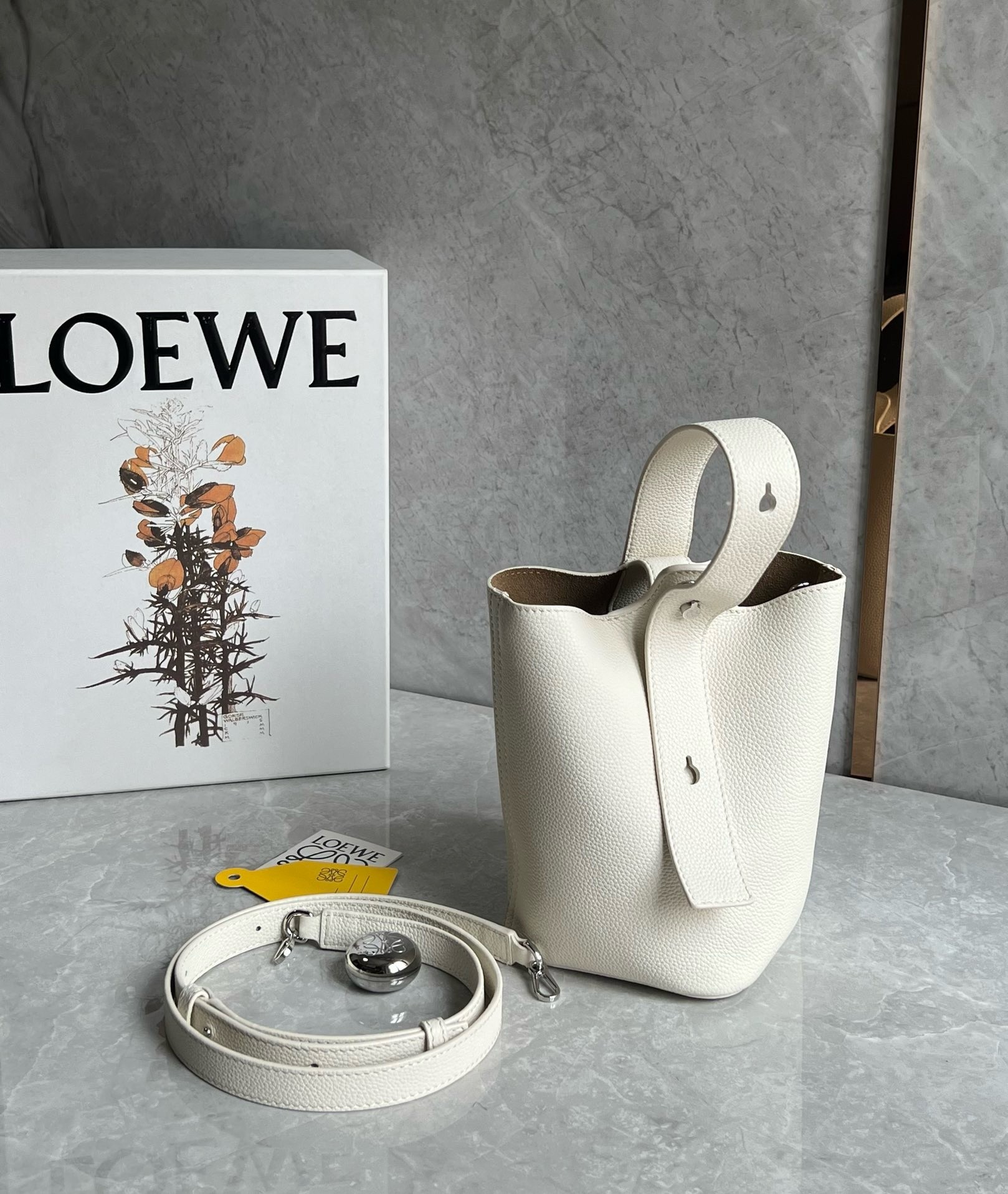 L0ew* mini pebble bucket bag in white grained leather
