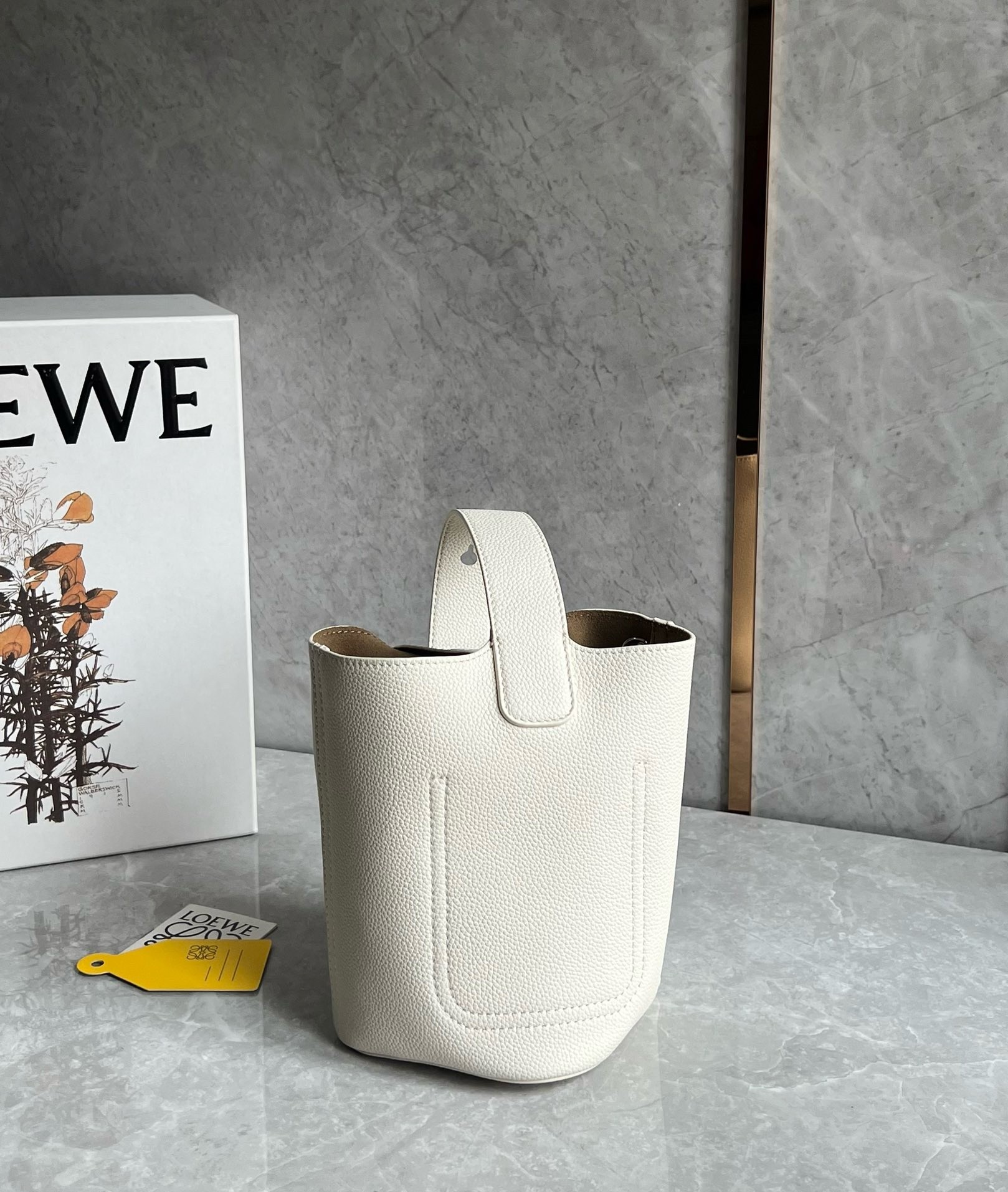 L0ew* mini pebble bucket bag in white grained leather