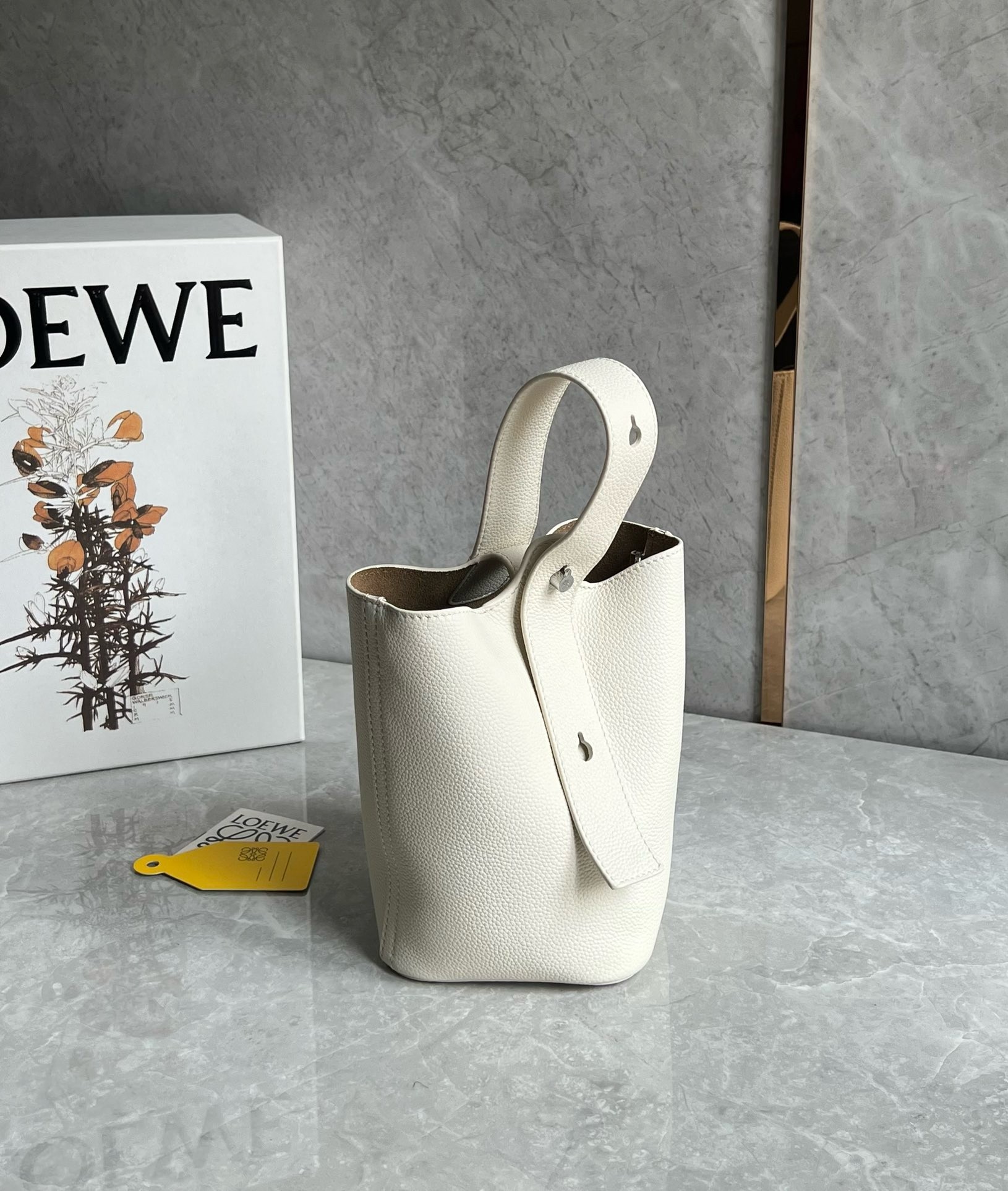L0ew* mini pebble bucket bag in white grained leather